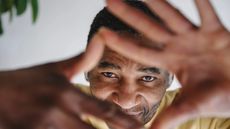 Mature man looking through finger frame