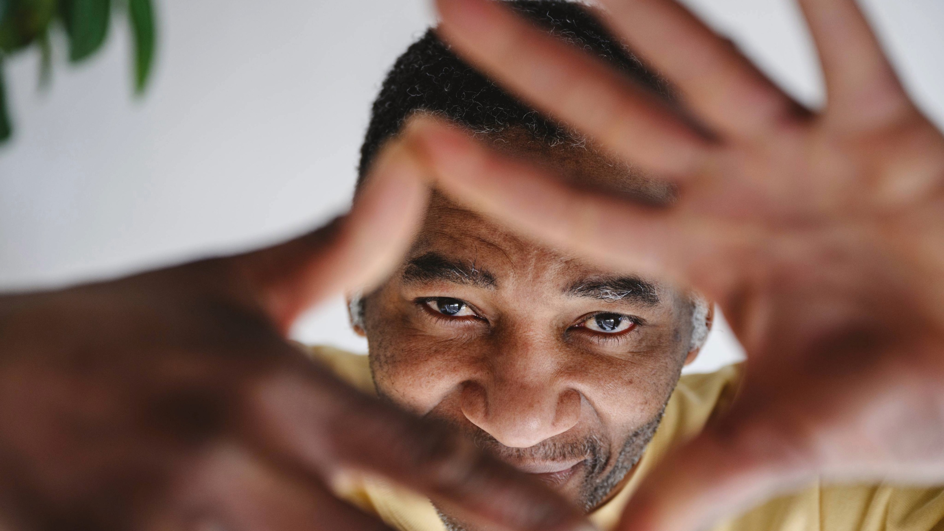 Mature man looking through finger frame