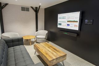 A SentryOne huddle room with the Crestron Flex B160 series Teams smart bar kit, as well as a TSW touchpanel with Microsoft Teams running.