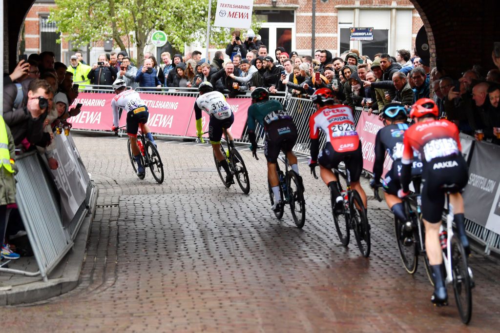 SCHOTEN BELGIUM APRIL 06 LR Edward Theuns of Belgium and Team Trek Segafredo Timothy Dupont of Belgium and Team Bingoal Pauwels Sauces WB Danny Van Poppel of Netherlands and Team Bora Hansgrohe and the peloton compete during the 110th Scheldeprijs 2022 Mens Elite a 1987km one day race from Terneuzen to Schoten SP22 on April 06 2022 in Schoten Belgium Photo by Luc ClaessenGetty Images