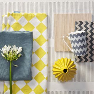 Detail shot of a decorating moodboard combining yellow and dark grey