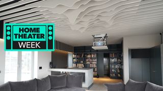 Home theater space with projector and sculptural elements on ceiling