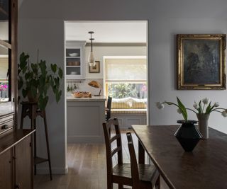 view from dining room to grey kitchen by Innen Studio
