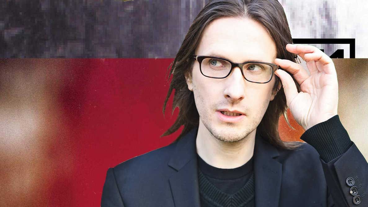 Steven Wilson in front of the artwork for The Fragile