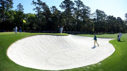 Harold Varner III plays a bunker shot during the Masters