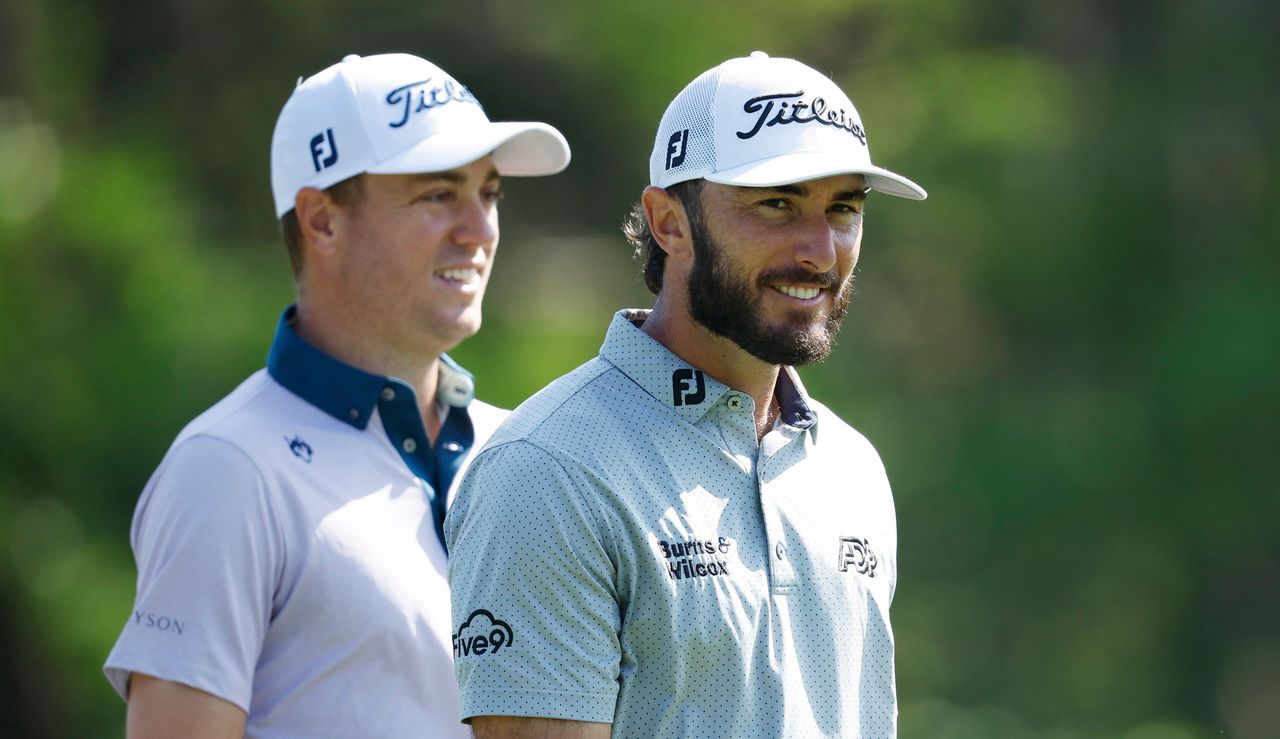 Justin Thomas and Max Homa walk down the fairway