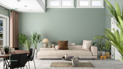modern green living room with neutral contemporary sofa and house plants to illustrate how to avoid common interior design mistakes