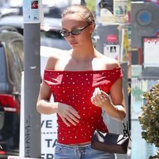 Lily Rose Depp wears an off-the-shoulder top.