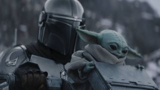Pedro Pascal's Din Djarin and Baby Yoda in the snow in The Mandalorian and Grogu