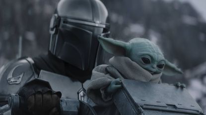Pedro Pascal's Din Djarin and Baby Yoda in the snow in The Mandalorian and Grogu 