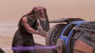 Jar Jar Binks trying to free his arm from a podracer engine in Star Wars: The Phantom Menace.