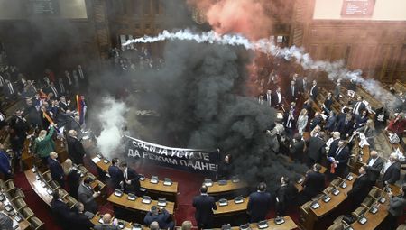 In this grab taken from video provided by RTS Serbia smoke bombs and flares are released in parliament, in Belgrade, Serbia, Tuesday, March 4, 2025