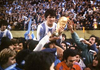 Argentine's national soccer team captain Daniel Passarella holds the World Cup trophy as he is carried on the shoulders of fans after Argentina defeated the Netherlands 3-1 in extra time, 25 June 1978 in Buenos Aires, during the World Cup soccer final. It is Argentina's first-ever World Cup title.