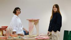 Artist Nat Maks and designer Brogan Cox stand among their marbled wood experiments