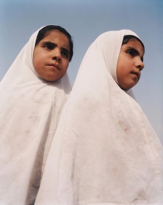 Two girls wearing berka's.