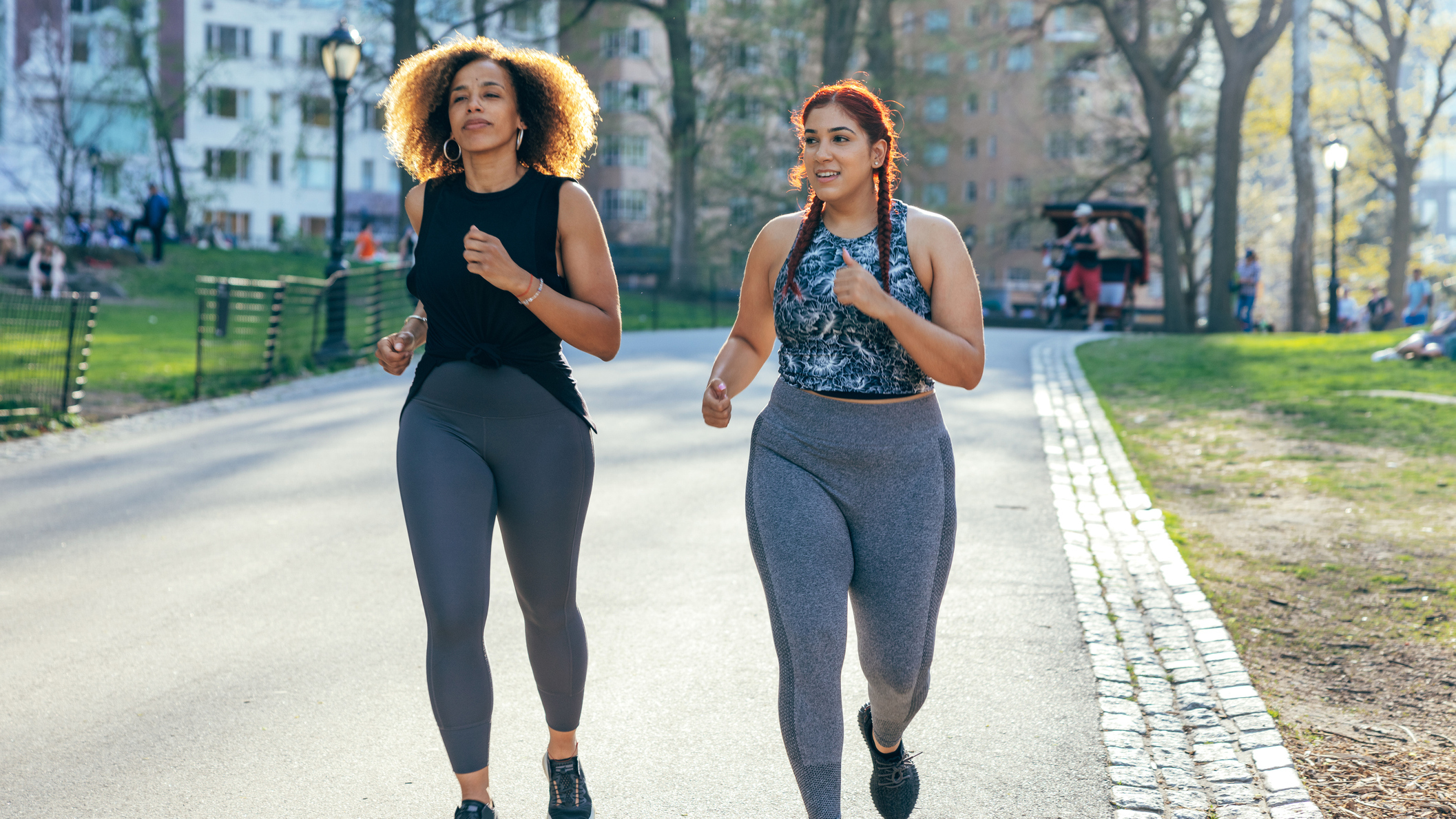 Two women running in a park