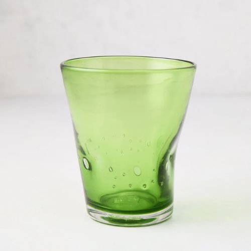 Pale green cocktail glass with conclave edges at the bottom and a wider rim