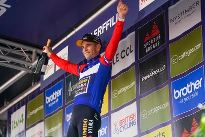 Wout van aert with a bottle of Champagne