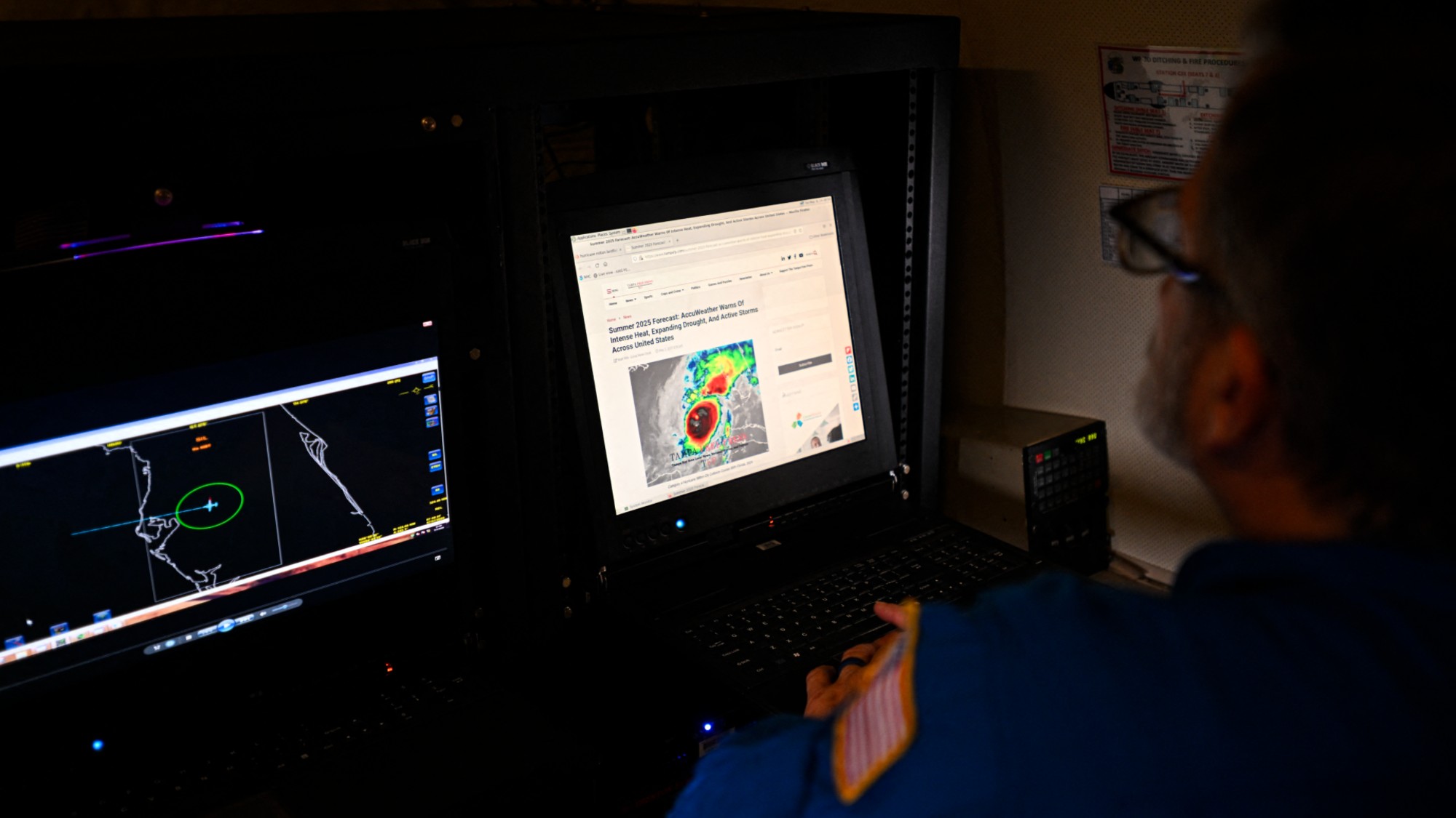 NOAAA crew member looks at a laptop inside a NOAA WP-3D Orion Hurricane Hunter research plane during a media day at the National Oceanic and Atmospheric Administration's (NOAA) Aircraft Operations Center in Lakeland, Florida, on May 6, 2025.