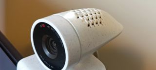 A white Poly Studio P5 webcam sitting on top of a monitor