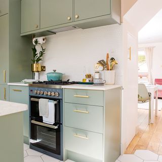 kitchen with green cabinets and cooker