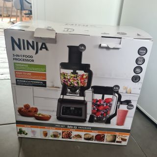 Ninja 3-in-1 Food Processor box on a dark grey floor