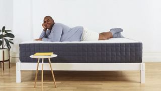 Best mattress for heavy people: image shows a man lying on his stomach on the Helix PLUS mattress