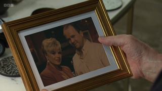 Sharon Watts gives Phil Mitchell a picture of them two from 30 years ago