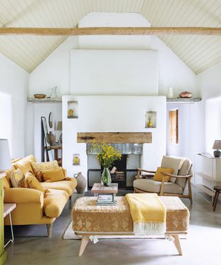 Yellow sofa, fireplace, white rug