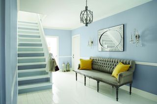 Hall and staircase with grey painted walls and alternate shades of grey for stair treads
