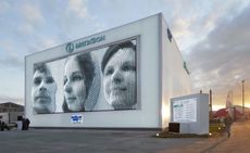 MegaFaces pavilion sits at the entrance of Sochi Olympic Park. There are three faces of people on the kinetic board.