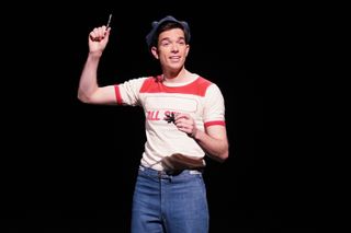 John Mulaney wearing a tshirt and jeans in a skit on snl