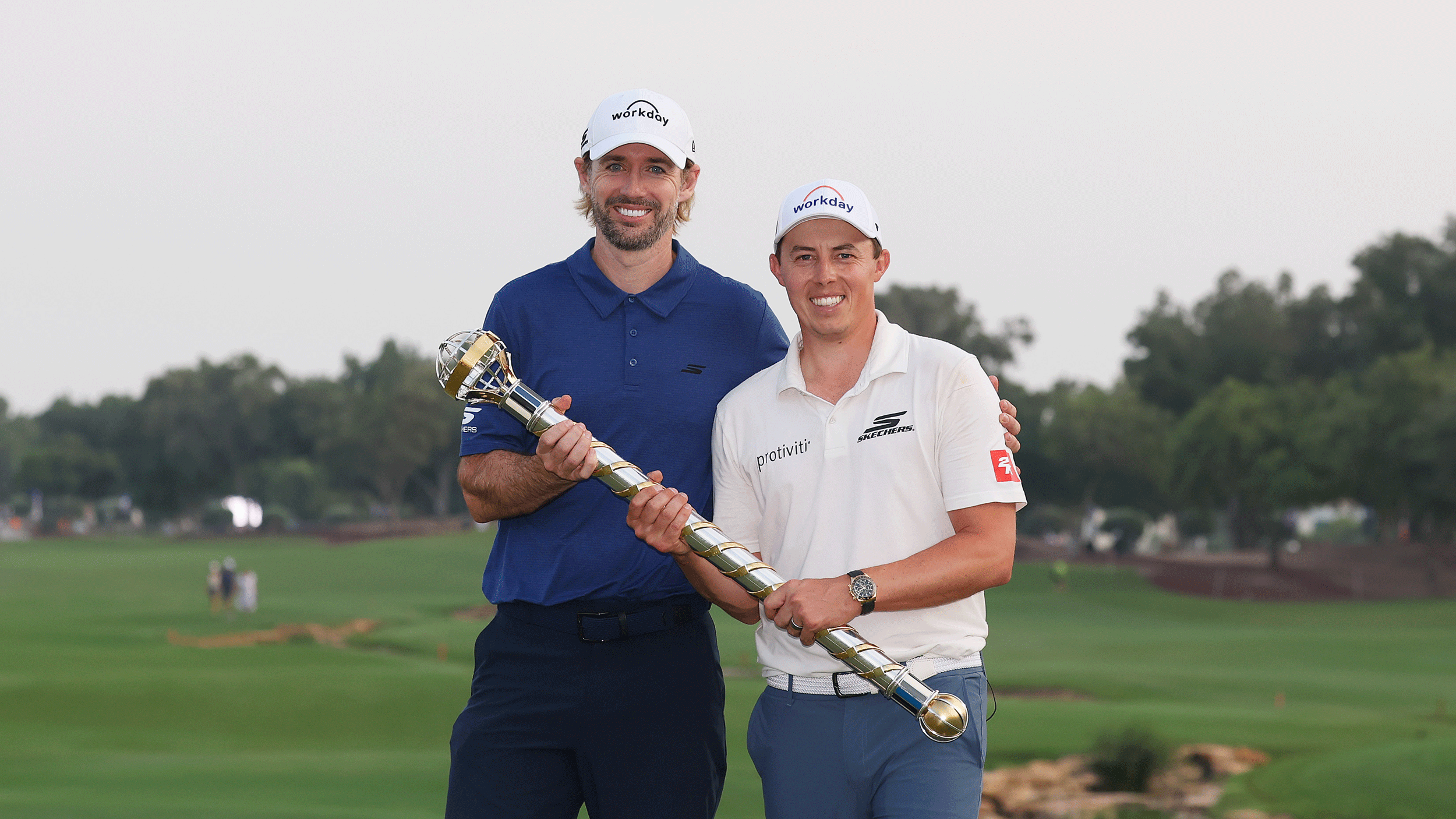 Matt Fitzpatrick (right) and his caddie Daniel Parratt pose with the DP World Tour Championship trophy following their win in 2025