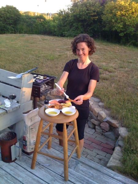 Mary McConneloug grills in the backyard.