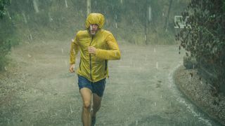 Athletic man jogging in extreme weather condition