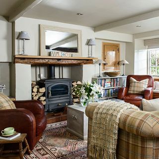 living room with fireplace and armchair with large mirror