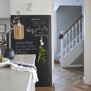 large black chalkboard with writing on in kitchen