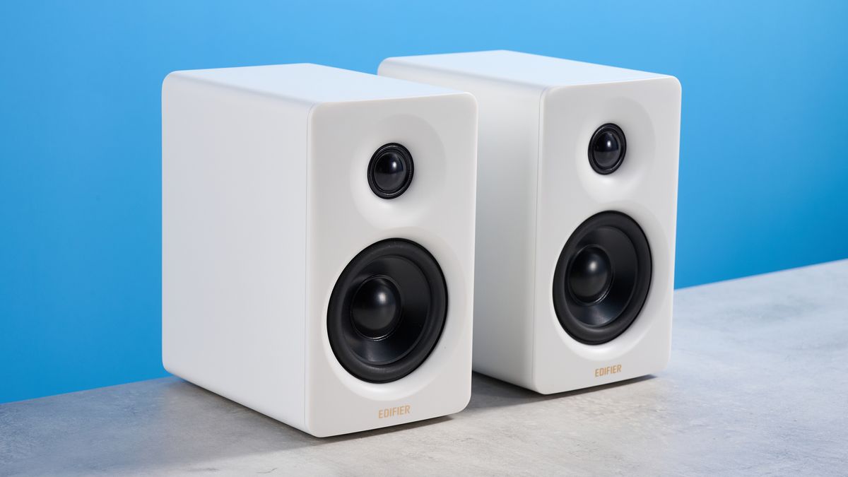 the edifier m60 bookshelf speakers in white photographed against the blue tom's guide background