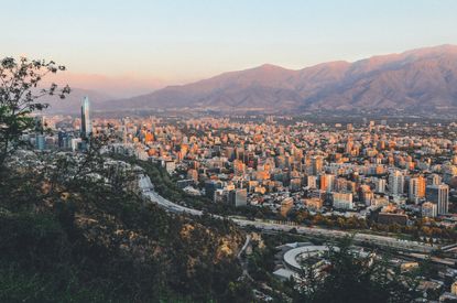An aerial view of a large city with mountains behind