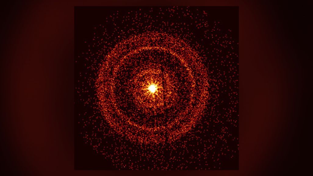 Image of the gamma-ray burst from the Swift observatory, showing a bright center surrounded by bands of orange circles.