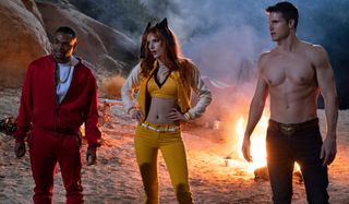 The Babysitter: Killer Queen Andrew Bachelor, Bella Thorne, and Robbie Amell with their backs turned to a roaring fire