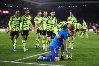 Arsenal goalkeeper Aaron Ramsdale is embraced by his team mates after full time during the Premier League match between Brentford FC and Arsenal FC at Gtech Community Stadium on November 25, 2023 in Brentford, England