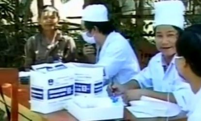 Doctors check villagers in Vietnam's Quang Ngai province after the resurgence of a mysterious illness spread by touch killed 19 people.