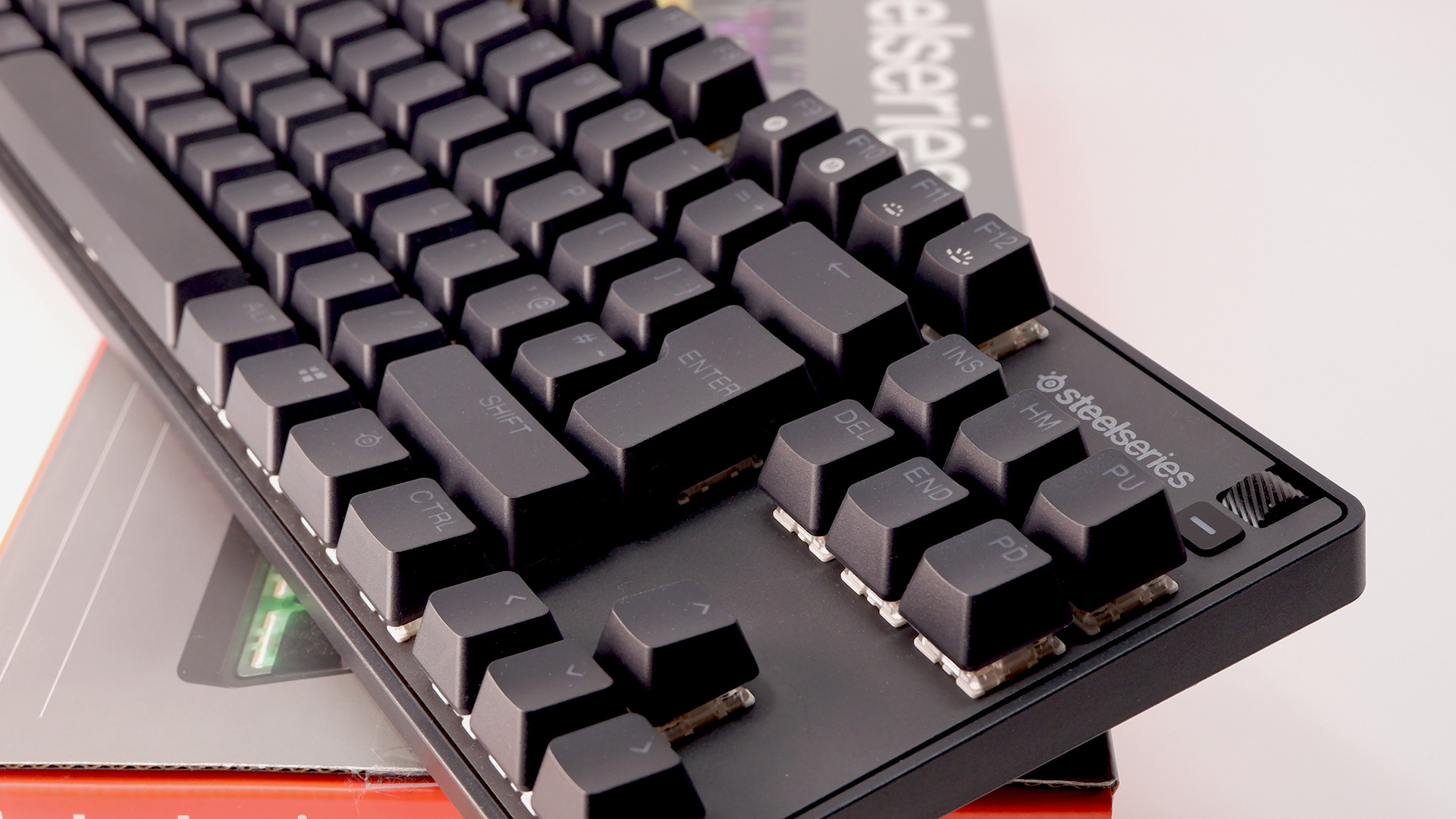 SteelSeries Apex 9 TKL gaming keyboard pictured on its box.