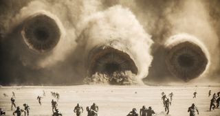 Three Sandworms attack in a scene from Dune: Part Two.