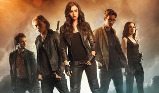 The Mortal Instruments: City of Bones Lily Collins flanked by her cast members in ominous smoke