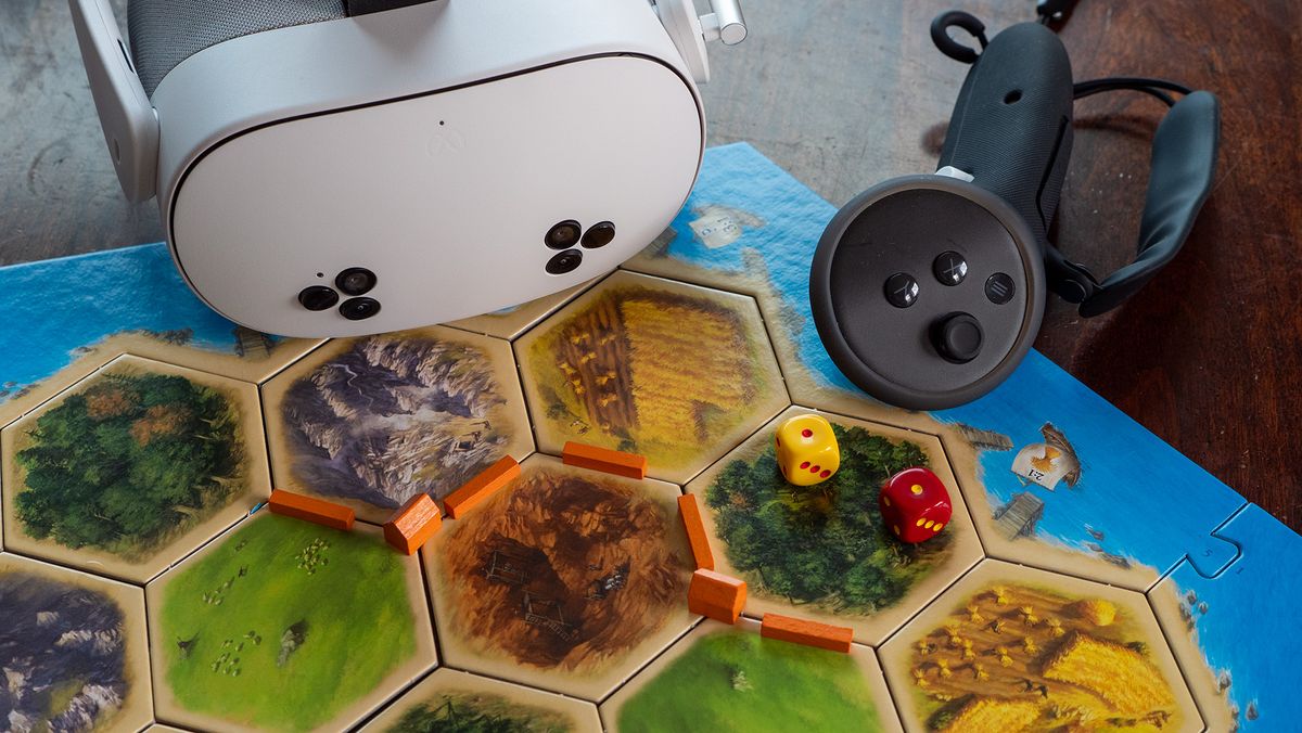 A Meta Quest 3S headset and controller on a Catan board