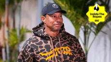 Tiger Woods walks into a TGL match wearing a print Sun Day Red hoodie with an Inside The Ropes tag in the top-right corner