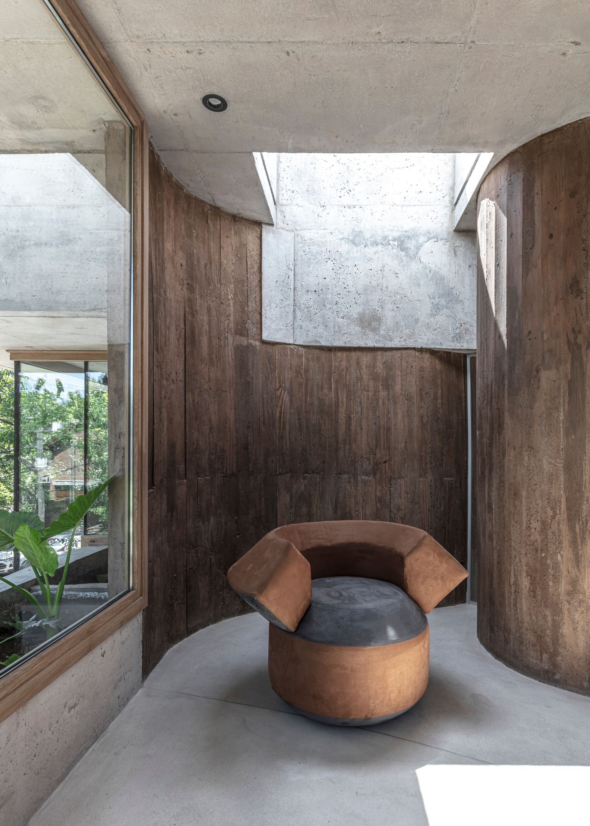 A bright nook with wooden walls and a brown chair