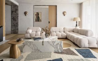 living room with white sofa, geometric print rug, marble coffee table